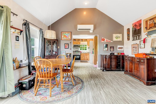 654 Bybee Rd, Louisa, VA 23093 - dining space with lofted ceiling, a wall mounted air conditioner, plenty of natural light, and light wood-style floors