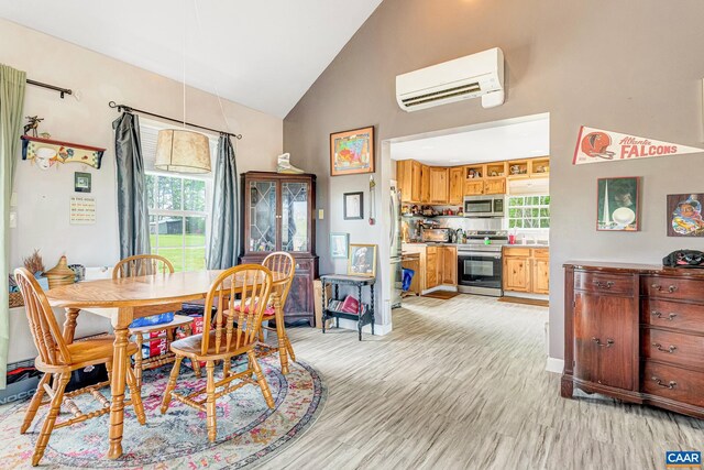 654 Bybee Rd, Louisa, VA 23093 - dining room featuring a wall mounted AC, high vaulted ceiling, and light wood finished floors