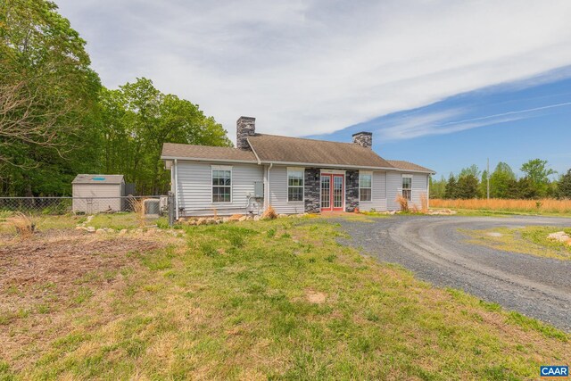 654 Bybee Rd, Louisa, VA 23093 - view of front of property featuring french doors, fence, a chimney, gravel driveway, and a shed