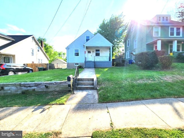 4503 Lasalle Ave, Baltimore, MD 21206 - bungalow featuring a front lawn, covered porch, and fence