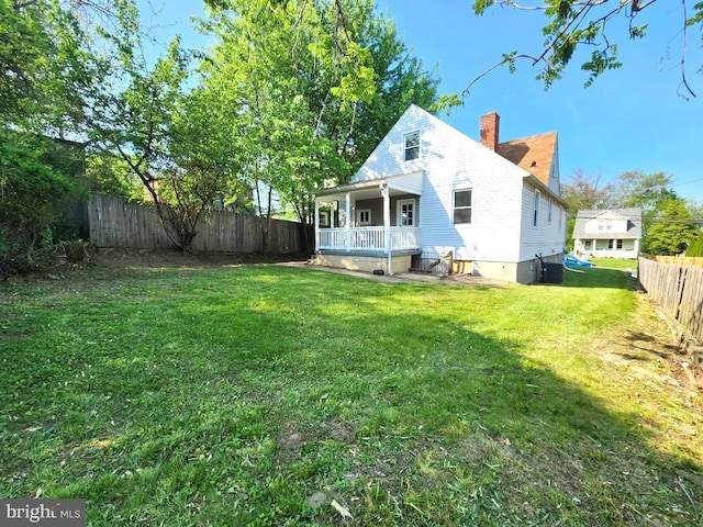 4503 Lasalle Ave, Baltimore, MD 21206 - back of property featuring covered porch, cooling unit, a chimney, a fenced backyard, and a yard