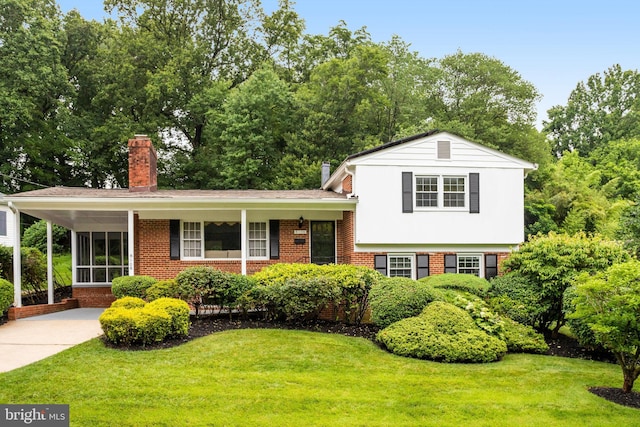 8108 Beech Tree Rd, Bethesda, MD 20817 - split level home featuring a chimney, brick siding, and a front lawn