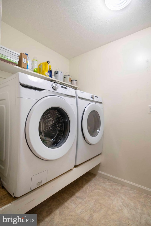 627 Ash St, Strasburg, VA 22657 - laundry room with washer and dryer, baseboards, and a textured ceiling