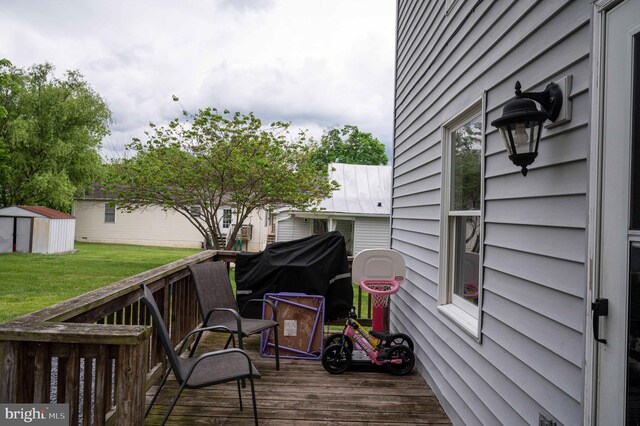 627 Ash St, Strasburg, VA 22657 - wooden terrace featuring a shed, a lawn, an outdoor structure, and grilling area