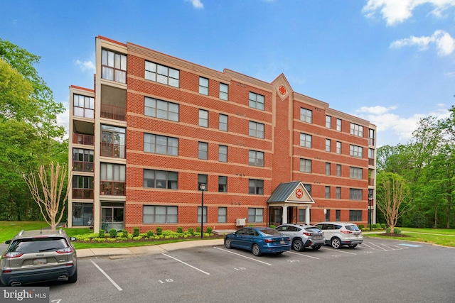 view of building exterior featuring uncovered parking