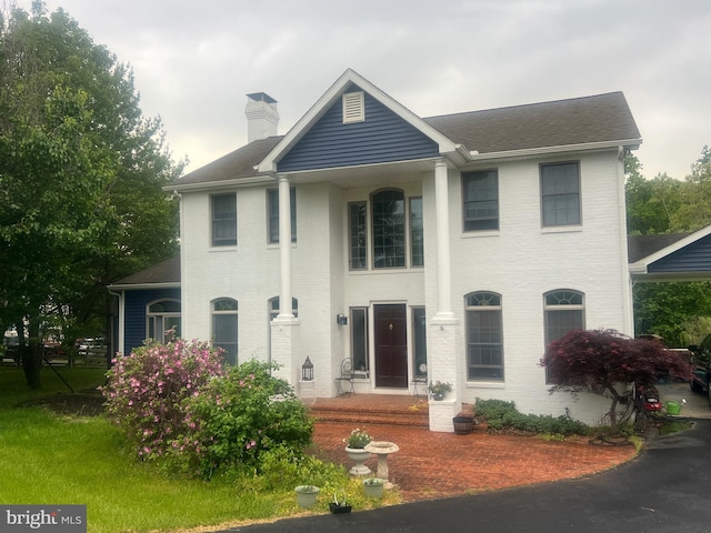 177 Pearce Creek Dr, Earleville, MD 21919 - neoclassical home with a chimney, brick siding, and a shingled roof