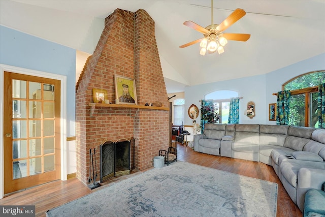 177 Pearce Creek Dr, Earleville, MD 21919 - living room with wood finished floors, ceiling fan, a brick fireplace, and high vaulted ceiling