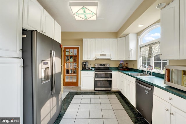 177 Pearce Creek Dr, Earleville, MD 21919 - kitchen featuring appliances with stainless steel finishes, a sink, dark countertops, under cabinet range hood, and tile patterned flooring