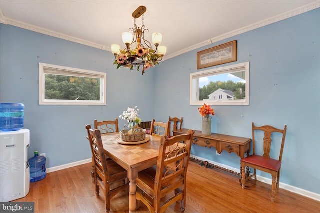 177 Pearce Creek Dr, Earleville, MD 21919 - dining area featuring healthy amount of natural light, wood finished floors, ornamental molding, a chandelier, and baseboards