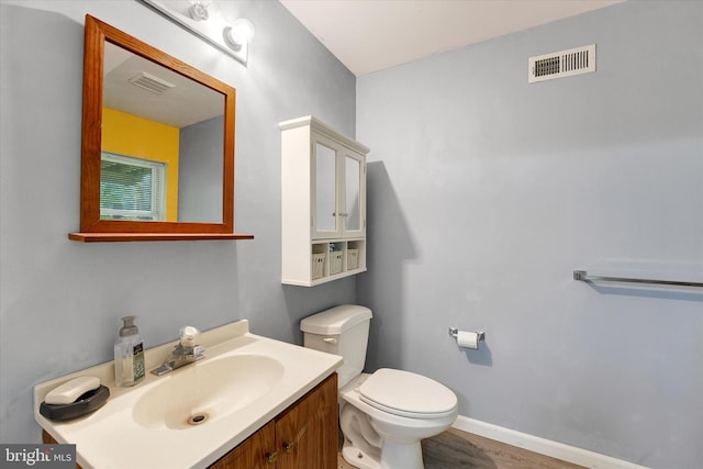 177 Pearce Creek Dr, Earleville, MD 21919 - half bathroom featuring toilet, vanity, baseboards, and wood finished floors