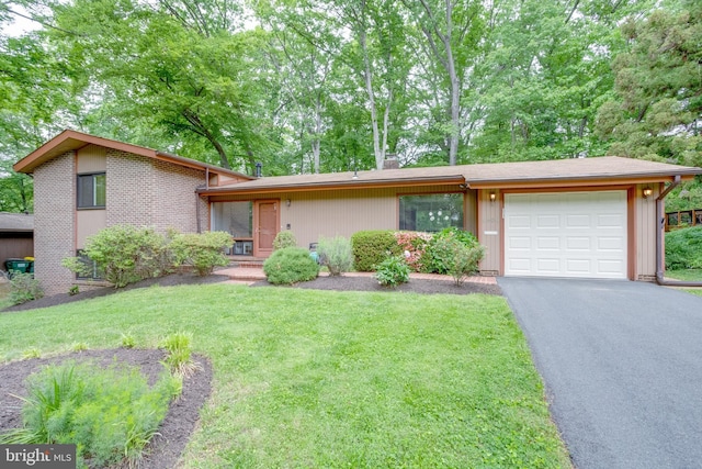 mid-century home featuring an attached garage, a front yard, and driveway
