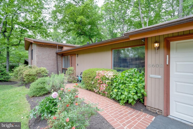 view of exterior entry with a garage