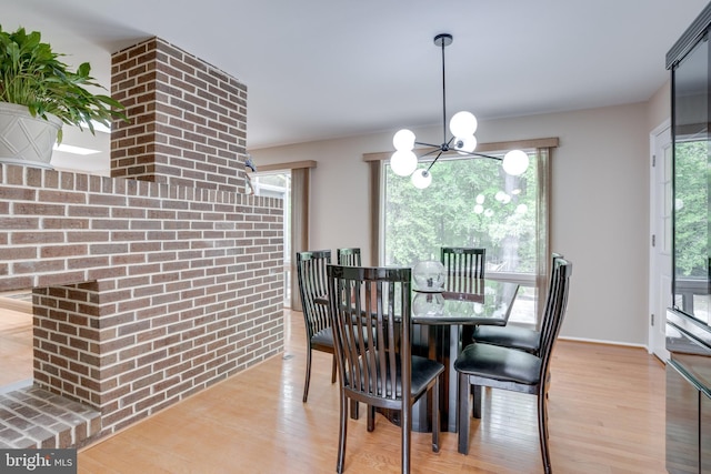 dining space with a chandelier and wood finished floors