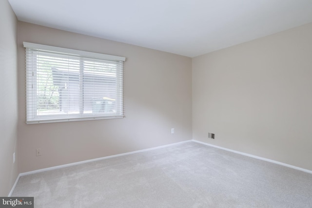 carpeted empty room with baseboards