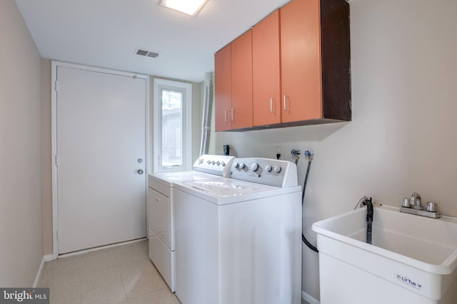 laundry room with cabinet space, washing machine and dryer, baseboards, and light flooring