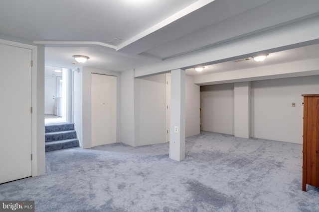 finished below grade area featuring carpet and stairs