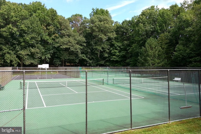 view of tennis court featuring fence