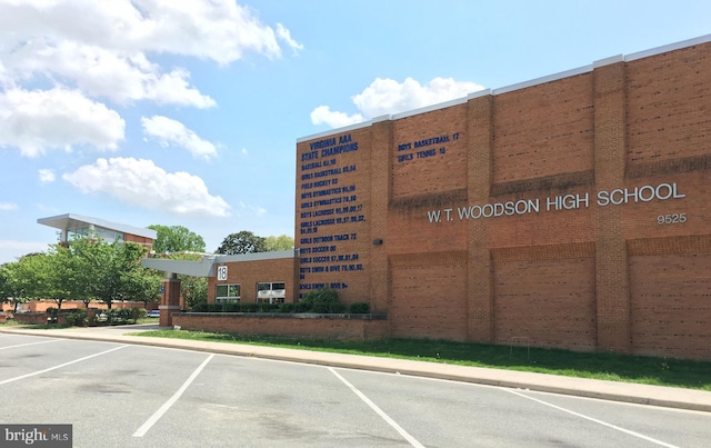 view of building exterior featuring uncovered parking