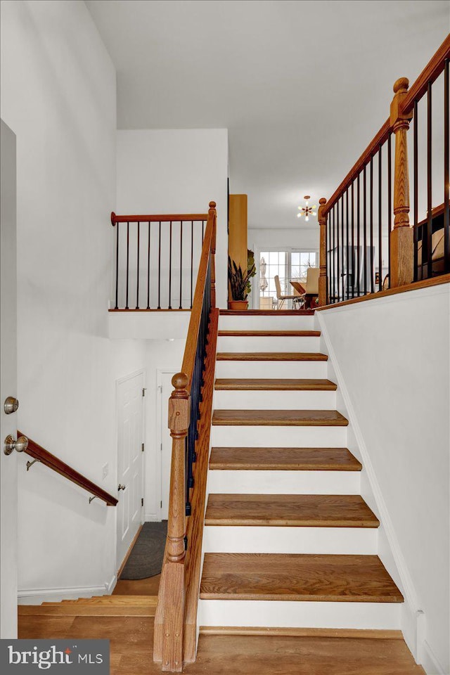 stairway featuring wood finished floors and baseboards