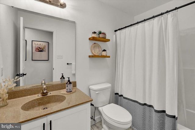 bathroom with toilet, vanity, and a shower with curtain