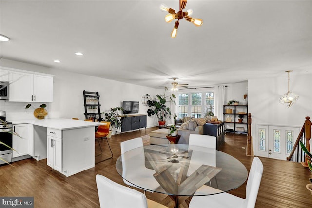 dining room with a chandelier, dark wood-style flooring, ceiling fan, and recessed lighting