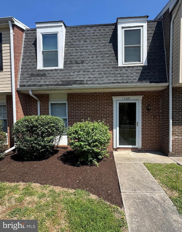1165 S Division St, Salisbury, MD 21804 - view of front facade featuring a shingled roof, brick siding, and mansard roof