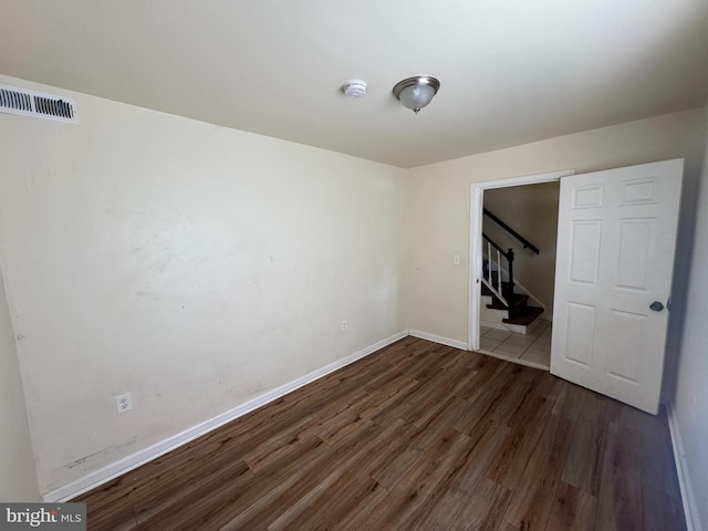 1165 S Division St, Salisbury, MD 21804 - empty room with visible vents, wood finished floors, baseboards, and stairway