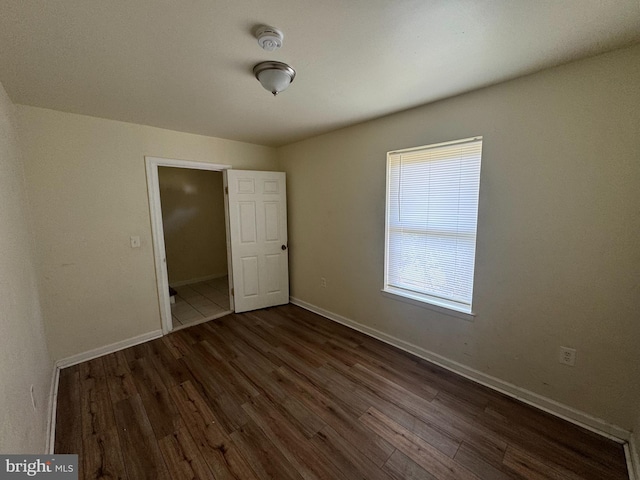 1165 S Division St, Salisbury, MD 21804 - unfurnished bedroom featuring baseboards and dark wood-style floors