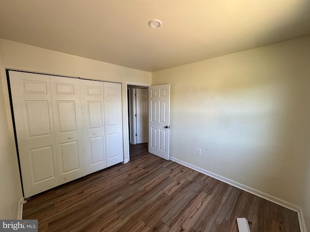 1165 S Division St, Salisbury, MD 21804 - unfurnished bedroom with baseboards, a closet, and dark wood finished floors