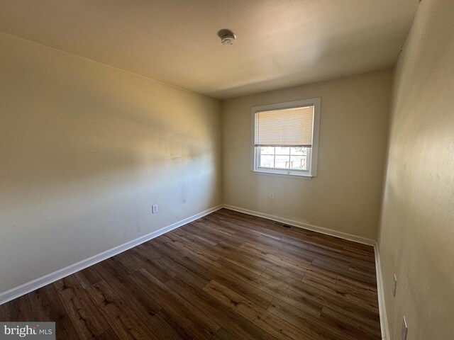 1165 S Division St, Salisbury, MD 21804 - spare room featuring baseboards, dark wood-style floors, and visible vents