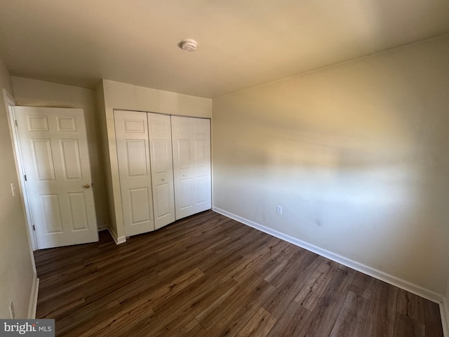 1165 S Division St, Salisbury, MD 21804 - unfurnished bedroom with baseboards, a closet, and dark wood-style floors