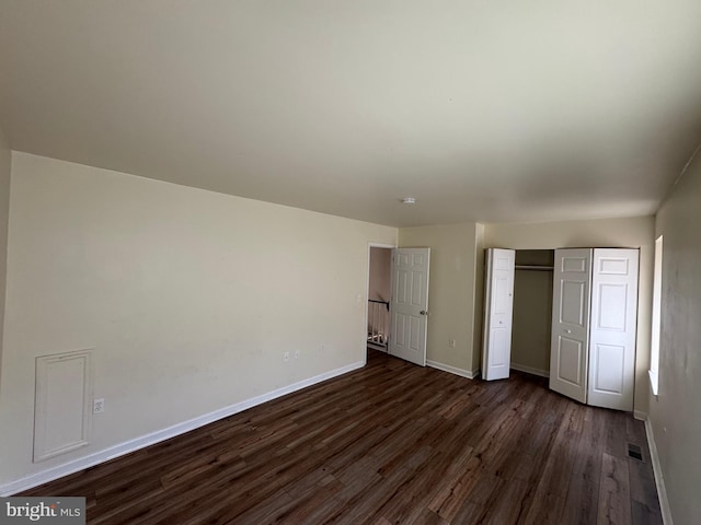 1165 S Division St, Salisbury, MD 21804 - unfurnished bedroom with a closet, dark wood-type flooring, baseboards, and visible vents