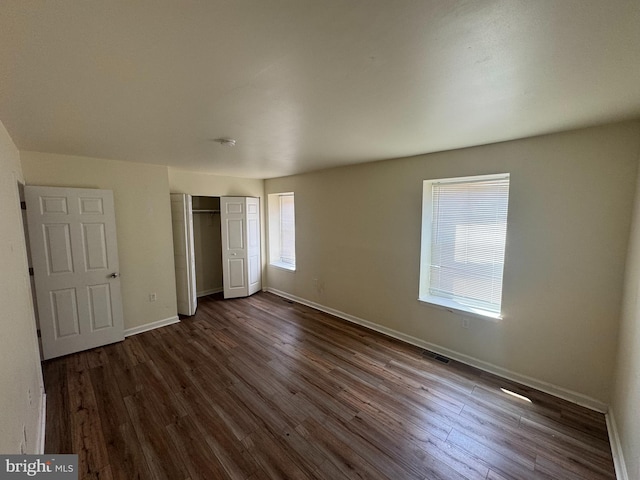 1165 S Division St, Salisbury, MD 21804 - unfurnished bedroom featuring baseboards, dark wood-style floors, a closet, and visible vents