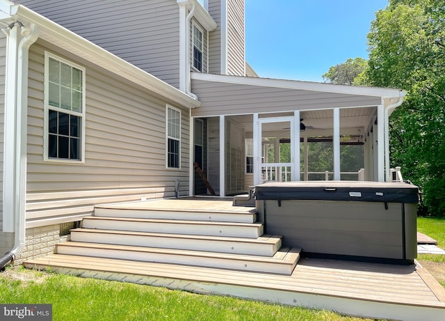exterior space featuring a hot tub, a wooden deck, and a ceiling fan