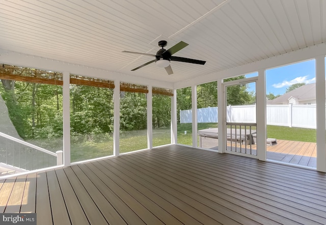 unfurnished sunroom featuring ceiling fan