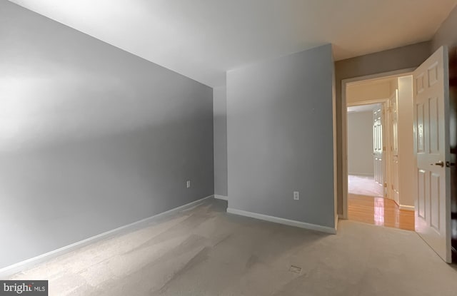 bonus room with baseboards and carpet floors
