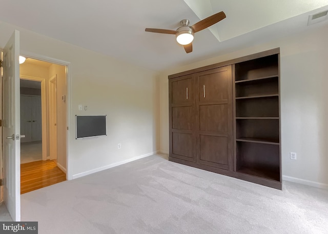 unfurnished bedroom with baseboards, a closet, visible vents, and light colored carpet