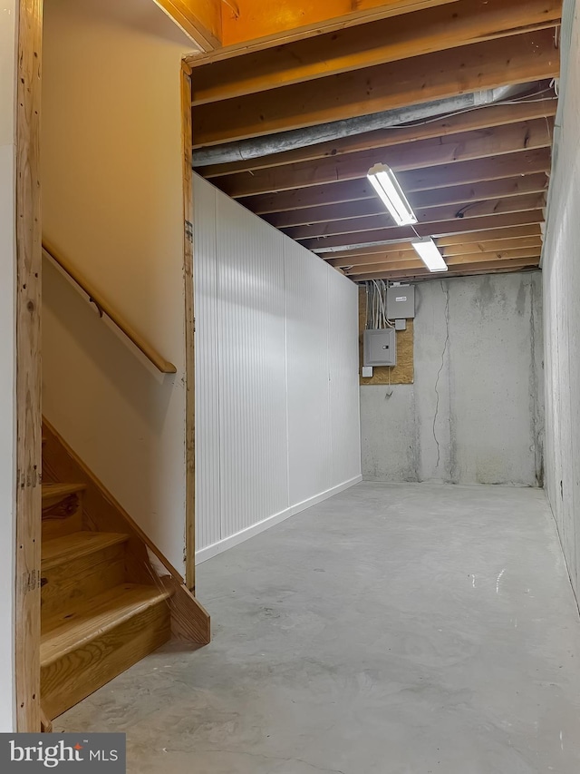 unfinished basement featuring stairs