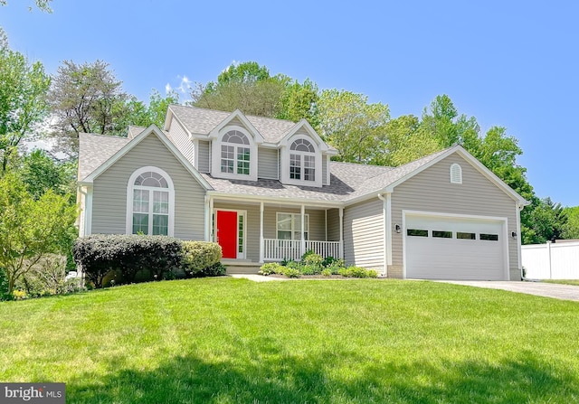 view of front of house featuring a porch, roof with shingles, concrete driveway, a garage, and a front yard