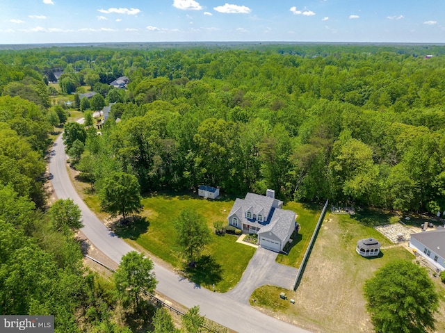 drone / aerial view featuring a wooded view