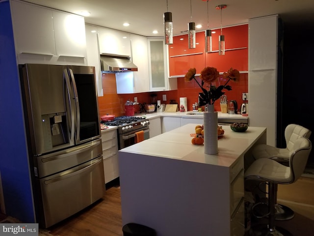 905 Pebble Ln, Southampton, PA 18966 - kitchen featuring a breakfast bar area, white cabinetry, exhaust hood, light countertops, and appliances with stainless steel finishes