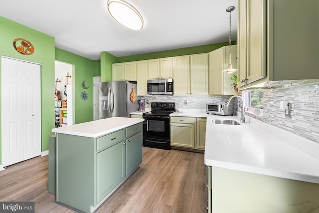1 Deep Pond Dr, Spring City, PA 19475 - kitchen featuring appliances with stainless steel finishes, green cabinetry, a sink, decorative backsplash, and light wood finished floors