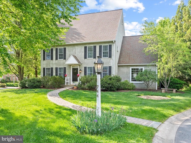 744 Goose Neck Dr, Lititz, PA 17543 - view of front facade with stucco siding, roof with shingles, and a front lawn