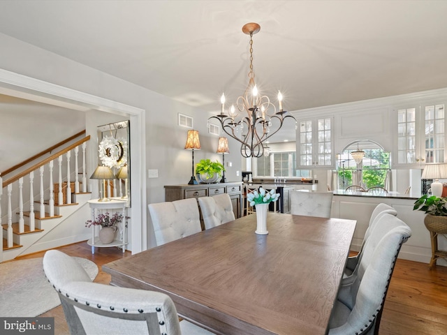 744 Goose Neck Dr, Lititz, PA 17543 - dining space with a chandelier, stairs, and hardwood / wood-style flooring