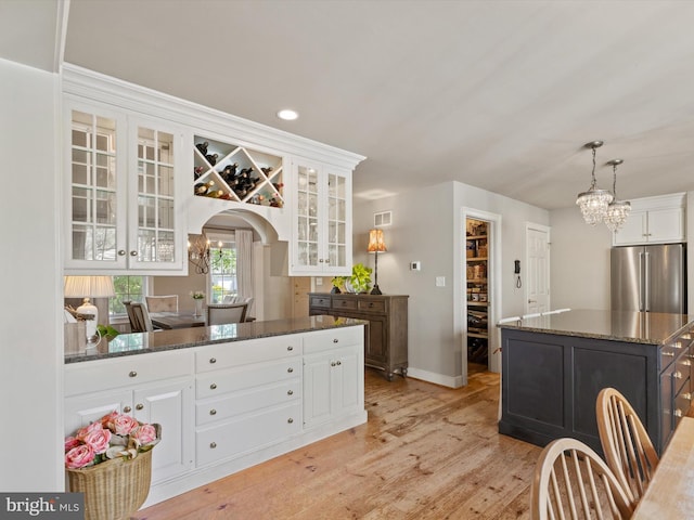 744 Goose Neck Dr, Lititz, PA 17543 - kitchen with high end fridge, white cabinets, a chandelier, dark stone countertops, and recessed lighting