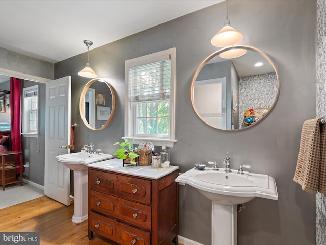 744 Goose Neck Dr, Lititz, PA 17543 - bathroom featuring wood finished floors, two sinks, and baseboards