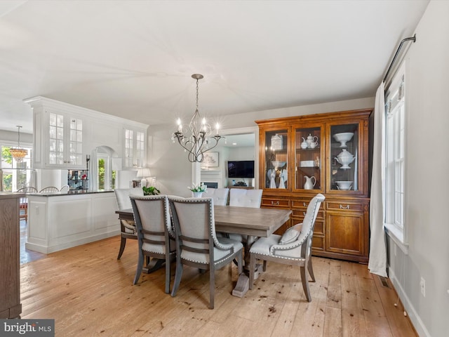 744 Goose Neck Dr, Lititz, PA 17543 - dining room with a chandelier, arched walkways, and light wood-style floors