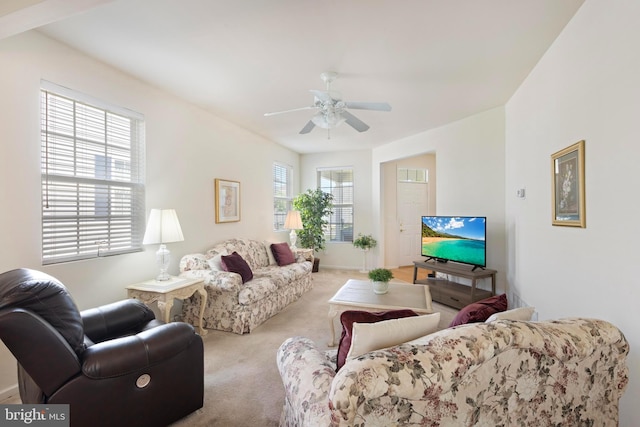 living room with carpet floors, a ceiling fan, and baseboards