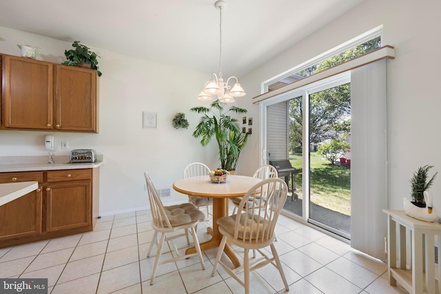 dining room featuring light tile patterned floors and a chandelier