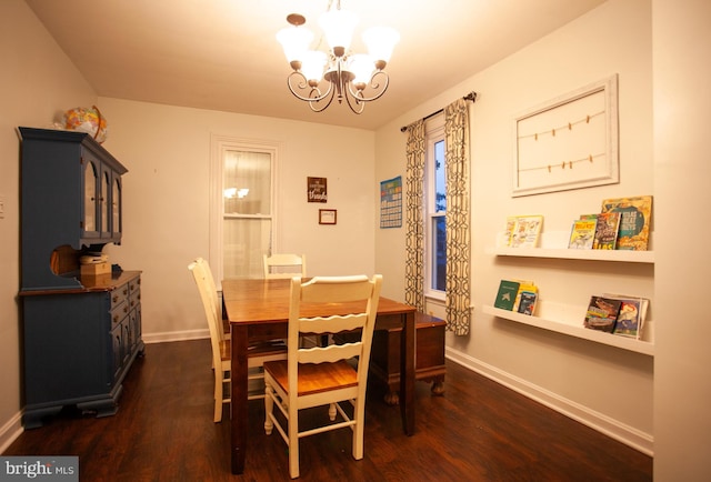 dining space with baseboards, dark wood-style flooring, and a notable chandelier